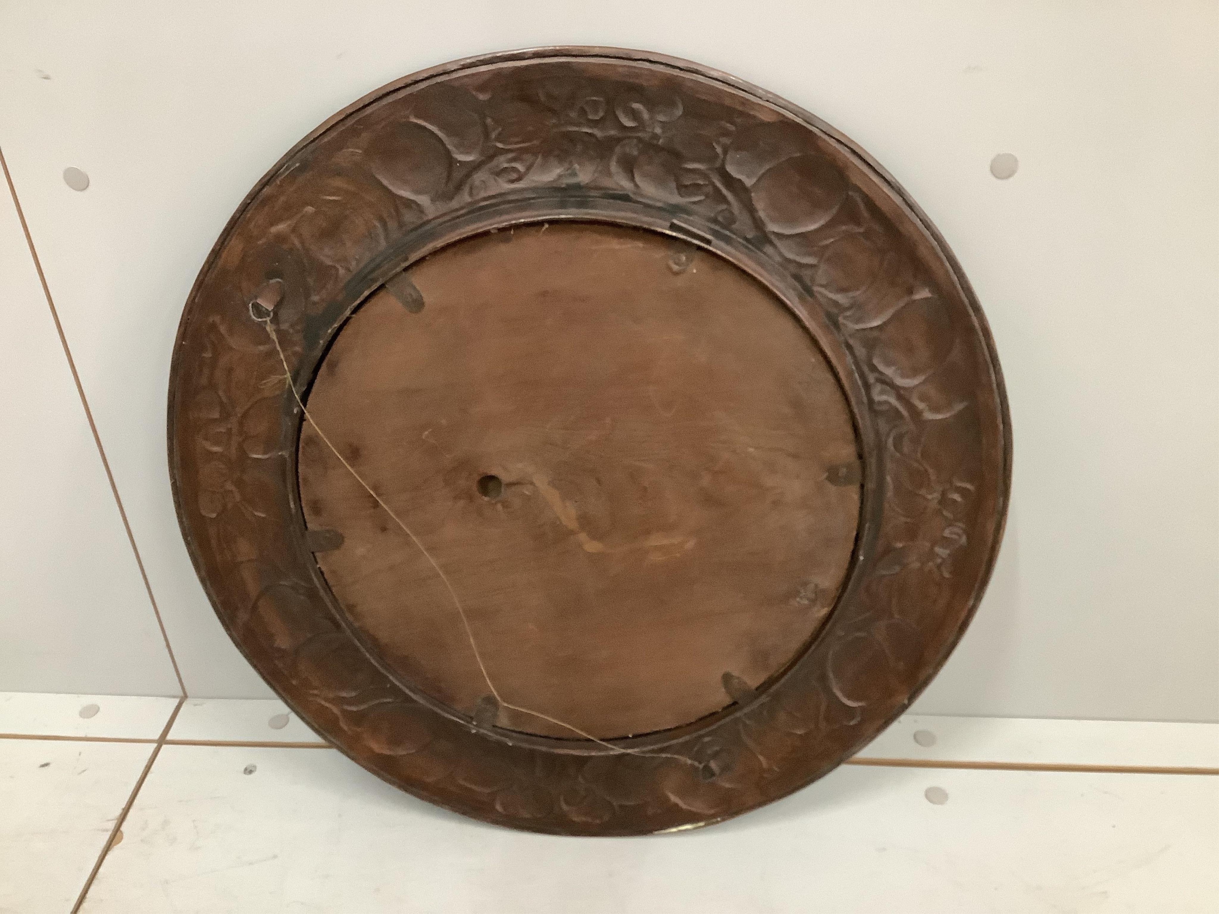 An Arts & Crafts circular embossed copper wall mirror, diameter 54cm. Condition - fair